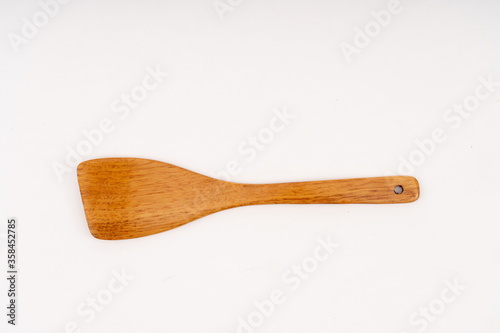 spade of frying pan made from wood on white background selective focus, kitchen flipper