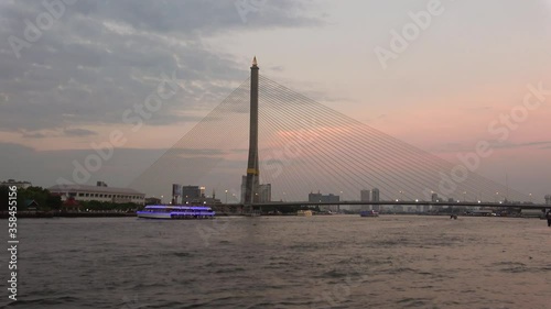 View of the Rama VIII bridge in the evening twilight. Bangkok, Thailand photo