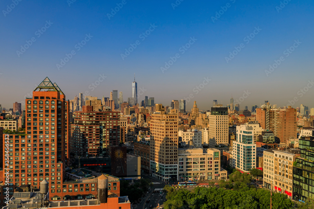 Aerial view of the iconic skyline and skyscrapers of New York Lower Manhattan on a hazy day
