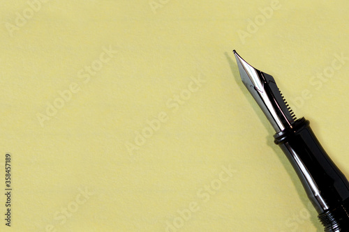 Black fountain pen on yellow paper.