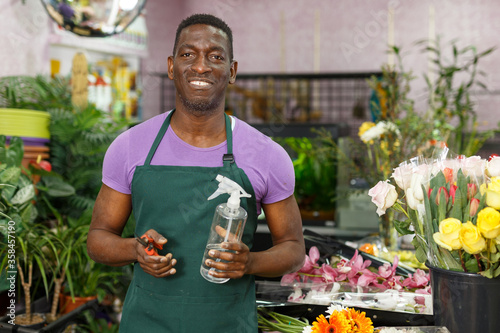 Man in apron posing in floral shop