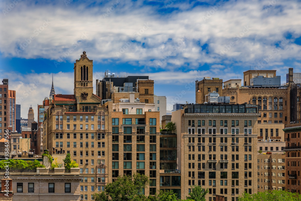 Aerial view of residential and office buildings in the iconic skyline in Midtown Manhattan on a cloudy day, New York USA