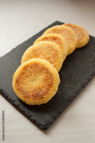 Vertical shot of some traditional moroccan semolina wheat Harsha bread pancakes freshly cooked plated on a blackboard. Harsha is a typical breakfast from the north of Africa.
