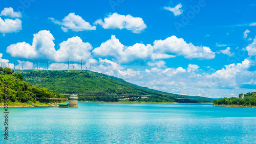 Landscape of lake sky with wind turbine and hightway at Lam Takhong Dam, Nakhon Ratchasima Province, Thailand