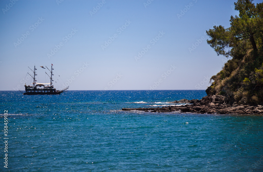 Ship in the sea on the horizon, view from the shore. Ship in the sea on the horizon, view from the shore.