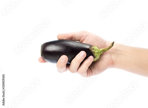 Hand holding an eggplant. Close up. Isolated on a white background