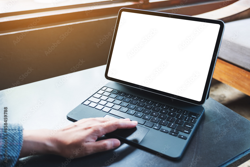 Mockup image of a woman using and touching on tablet touchpad with blank white desktop screen as a computer pc Mockup image of a woman using and touching on tablet touchpad with blank white desktop screen as a computer pc