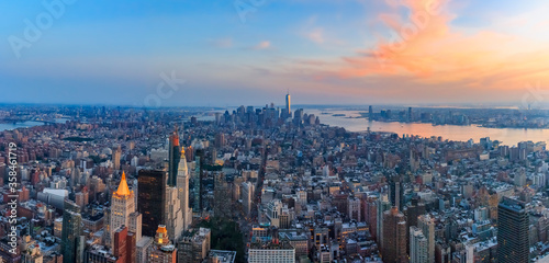 New York Downtown and lower Manhattan skyline view with the One World Trade Center skyscraper at sunset