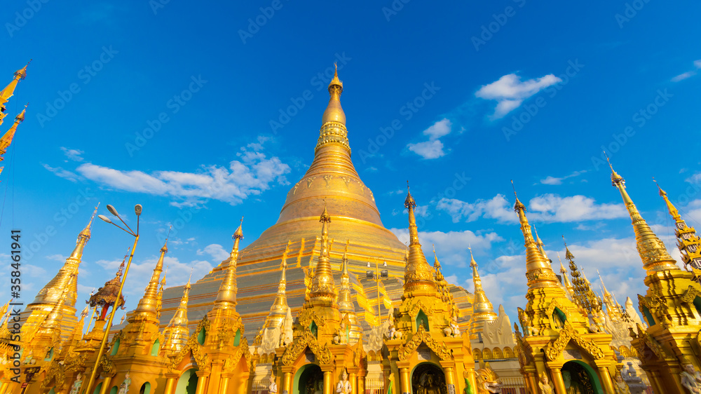 Fototapeta premium Buddhist Pilgrims in the Shwedagon Pagoda at night. It is the most sacred Buddhist pagoda for the Burmese. decoration image contain​ certain​ grain​ noise and​ soft​ focus.