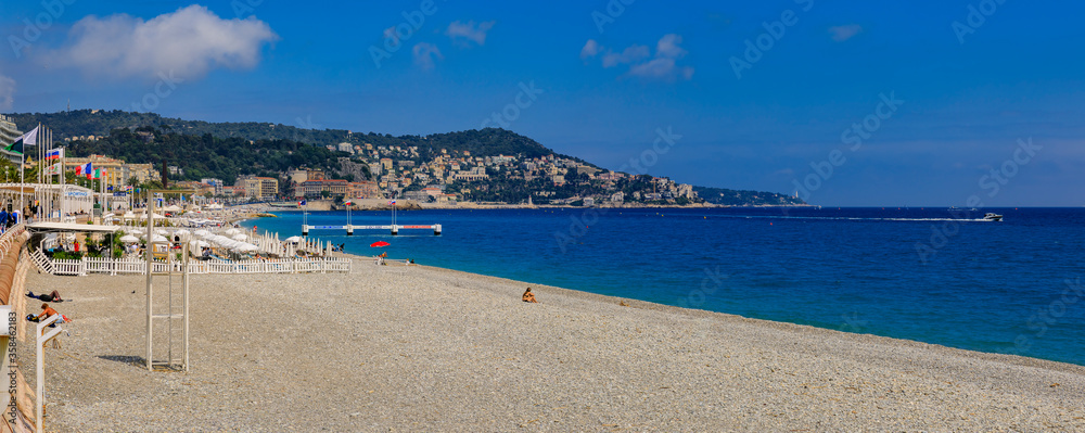 Obraz premium Pebble beach near famous Promenade des Anglais with the Mediterranean Sea in the background, Nice France