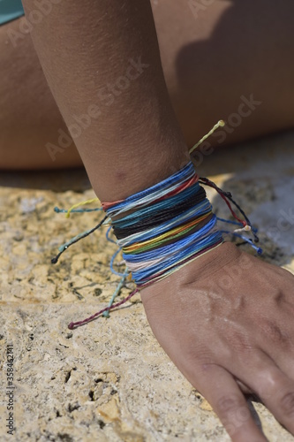 woman with armbands touching the edge of the pool with her fingers