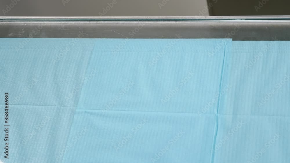 Wiping table with antibacterial alcohol napkin. Cleaning and disinfection of surfaces in clinic. Disinfection wet disposable wipes. Hands with medical gloves white wipe surface. Prevention and control Wiping table with antibacterial alcohol napkin. Cleaning and disinfection of surfaces in clinic. Disinfection wet disposable wipes. Hands with medical gloves white wipe surface. Prevention and control