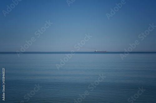 Ship on the horizon against the blue sea and sky © Gergana