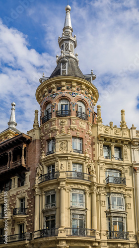 Beautiful traditional residential buildings with metal balconies in the streets of the city center in Madrid, Spain