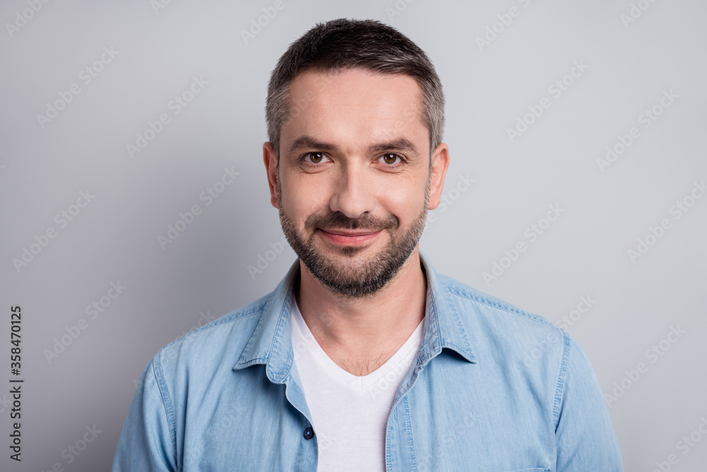 Close-up portrait of his he nice attractive content cheery mature guy private company worker wearing blue shirt isolated over gray light pastel color background Close-up portrait of his he nice attractive content cheery mature guy private company worker wearing blue shirt isolated over gray light pastel color background