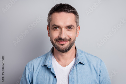Close-up portrait of his he nice attractive content cheery mature guy private company worker wearing blue shirt isolated over gray light pastel color background