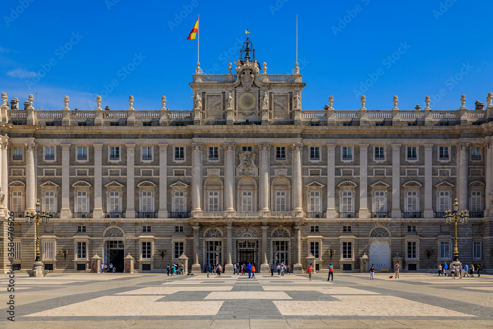 View of the ornate architecture of the Royal Palace or Palacio Real facade and Plaza de la Armeria in Madrid, Spain