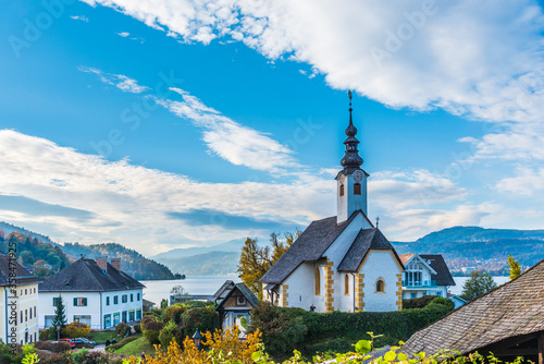 Magical Gothic architecture in Austria. Panorama on Lake Worthersee. Maria Worth church and sanctuary. photo