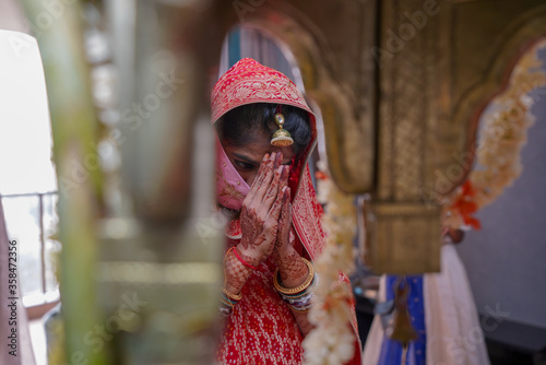 woman in traditional clothing joining both the hands to the god 