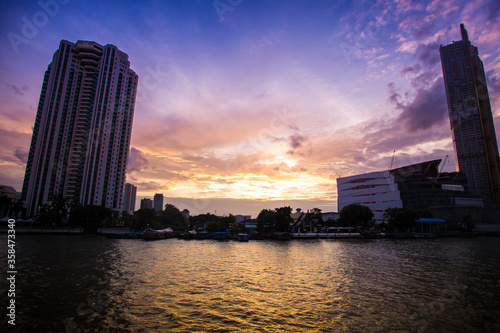 Sunset between the buildings on the Chao Phraya River.