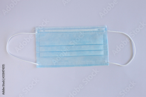Medical blue mask to protect coronavirus, infection and contaminated air, on white background.