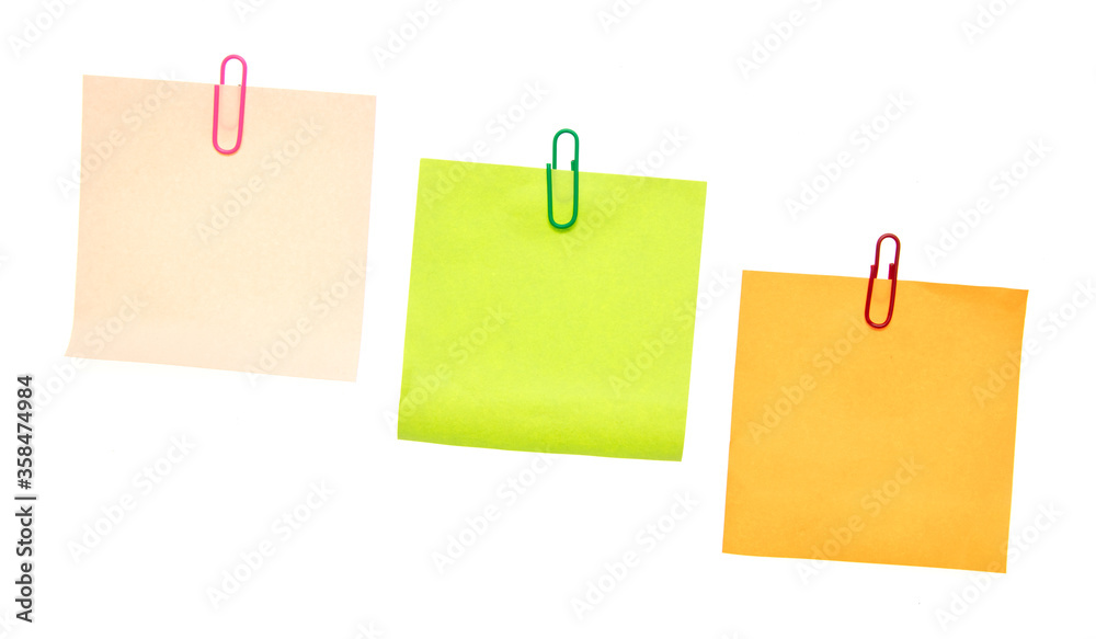 Colored pieces of paper with paper clips on a white background. Colored pieces of paper with paper clips on a white background.