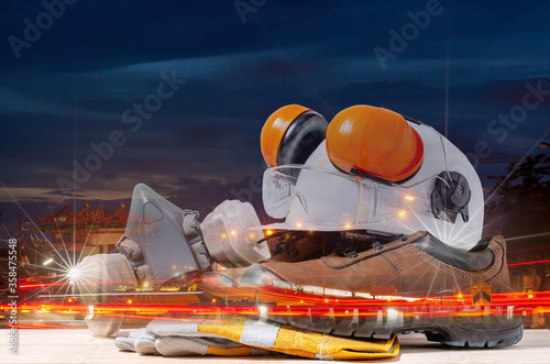 double exposure of standard consruction safety equipment with blur construction site background photo