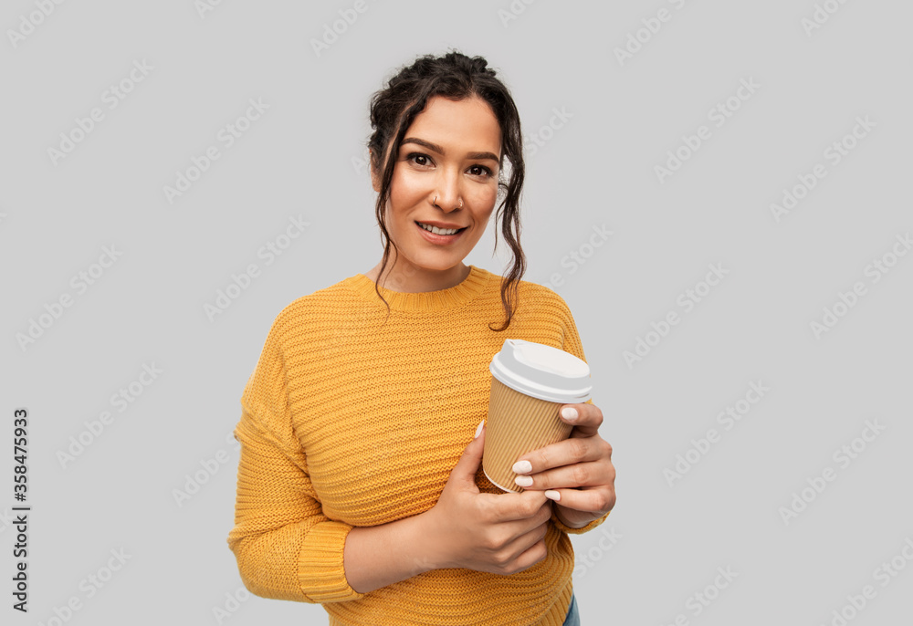 people concept - portrait of happy smiling young woman with pierced nose holding takeaway coffee cup over grey background people concept - portrait of happy smiling young woman with pierced nose holding takeaway coffee cup over grey background
