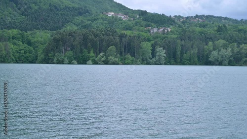 Mountain lake, forest and sky. Beautiful nature in a park reserve in the north of Italy. Calm atmosphere photo
