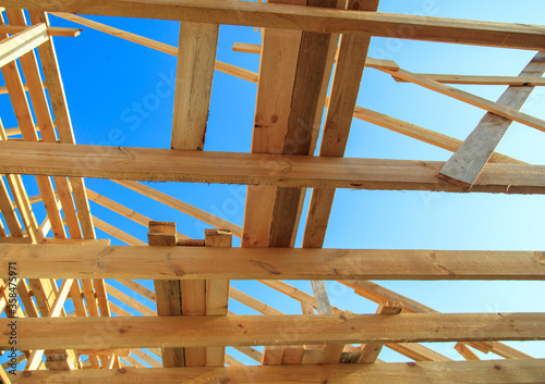 Wooden boards on the roof of the house against the sky.