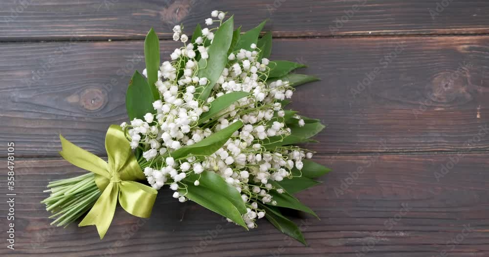 Bouquet of beautiful white flowers. Lilie of the valley on the board. 4K
