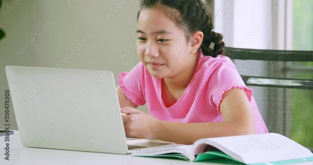 A girl studying online distance learning while quarantine at home. A girl studying online distance learning while quarantine at home.