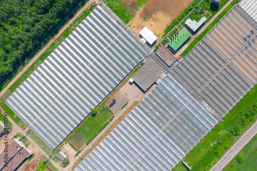 Top aerial view over large greenhouses for growing vegetable and flower crops.
