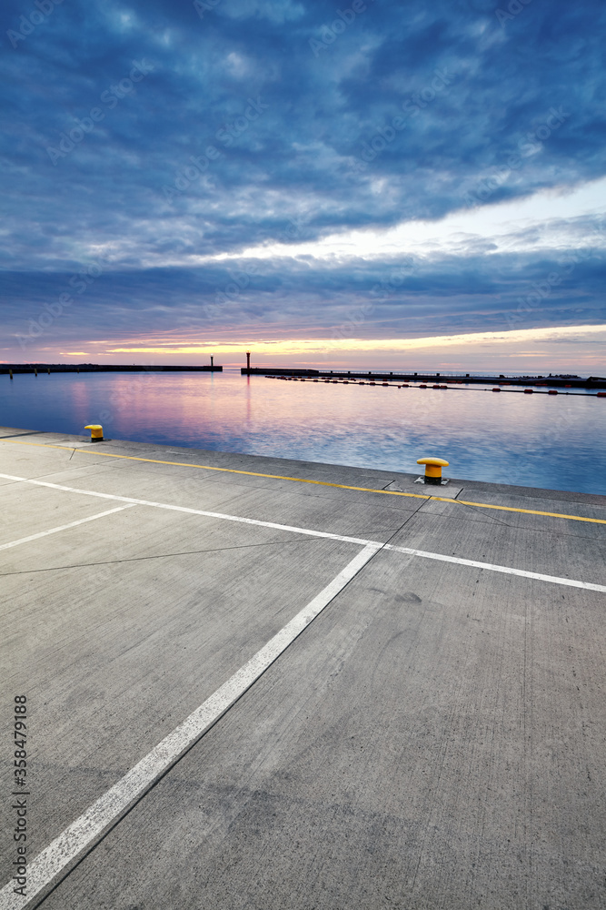 Parking lot in a harbor during the blue hour.