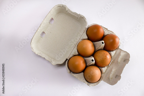 Half dozen egg in grey carton box on white background photo