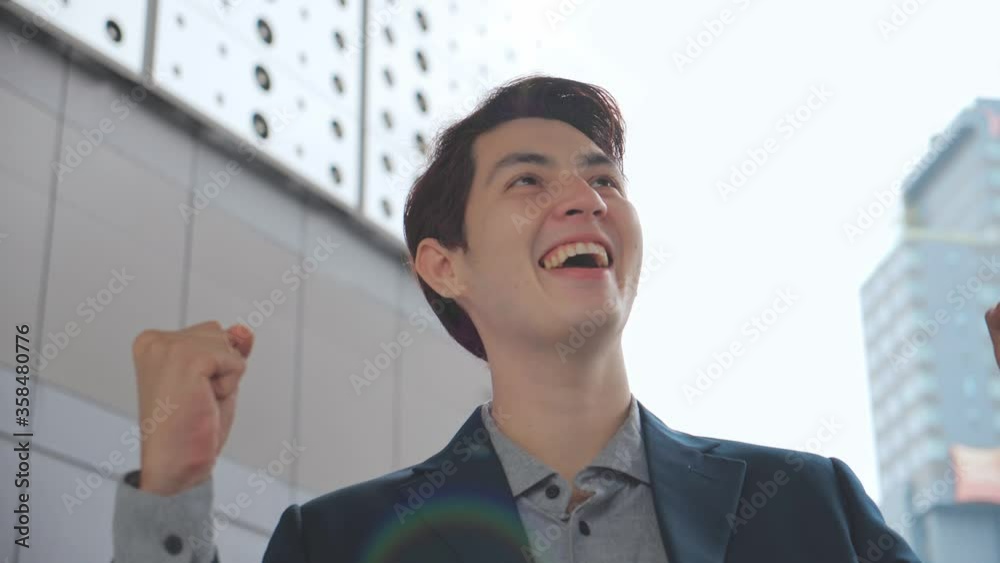 Excited young business man feeling happy receiving new job opportunity, reward bonus, celebrates financial market growth concept. Slow motion Excited young business man feeling happy receiving new job opportunity, reward bonus, celebrates financial market growth concept. Slow motion