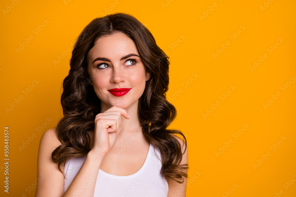 Closeup photo of pretty cunning curly lady red lipstick look curious empty space clever cruel idea hand on chin wear white casual tank-top isolated bright yellow color background Closeup photo of pretty cunning curly lady red lipstick look curious empty space clever cruel idea hand on chin wear white casual tank-top isolated bright yellow color background