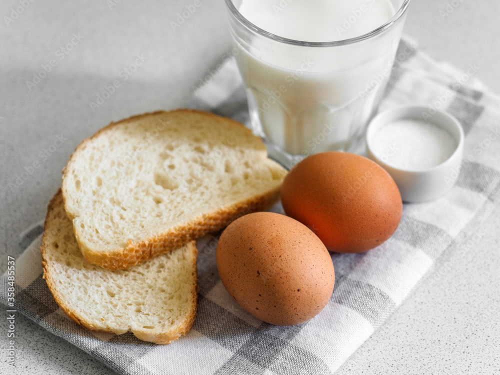 Breakfast ingredients. Still life of eggs, milk and bread on a white background. Close-up Breakfast ingredients. Still life of eggs, milk and bread on a white background. Close-up