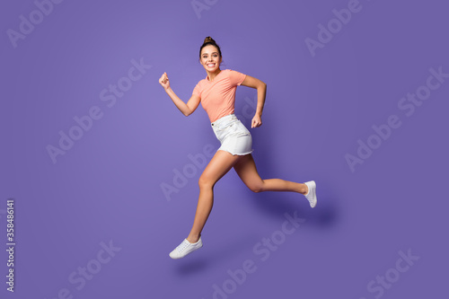 Full length body size view of her she nice attractive lovely purposeful healthy cheerful girl jumping running isolated on bright vivid shine vibrant lilac violet purple color background