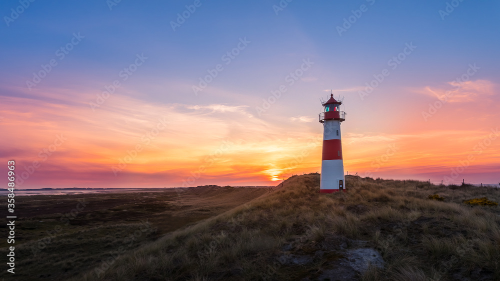Lighthouse Sylt List east - Ellenbogen at sunset with beautiful red and yellow clouds - high dynamic range Lighthouse Sylt List east - Ellenbogen at sunset with beautiful red and yellow clouds - high dynamic range