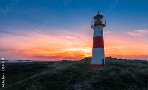Lighthouse Sylt List east - Ellenbogen at sunset with beautiful red and yellow clouds - high dynamic range