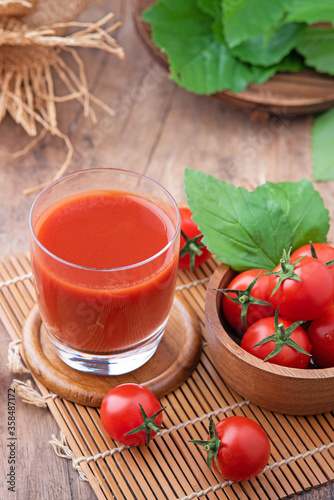 Tomato juice. Glass of tomato juice with vegetables on wooden background