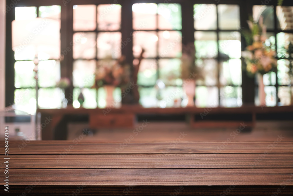 Empty wooden desk space platform and blurred restaurant or coffee shop background for product display montage.