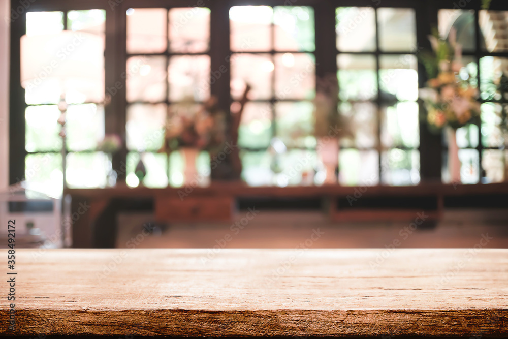 Empty wooden desk space platform and blurred restaurant or coffee shop background for product display montage.