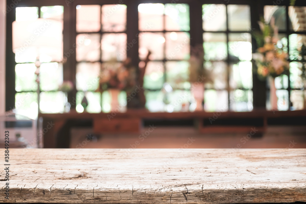 Empty wooden desk space platform and blurred restaurant or coffee shop background for product display montage. Empty wooden desk space platform and blurred restaurant or coffee shop background for product display montage.
