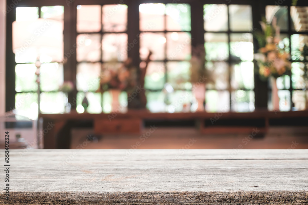 Empty wooden desk space platform and blurred restaurant or coffee shop background for product display montage. Empty wooden desk space platform and blurred restaurant or coffee shop background for product display montage.