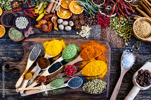 Fototapeta Naklejka Na Ścianę i Meble -  Many multi colored spices and dried fruits on the table