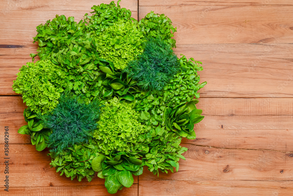 Spinach, parsley, dill, luttuce salad, mint. Creative layout made of green leaves. Flat lay. Spinach, parsley, dill, luttuce salad, mint. Creative layout made of green leaves. Flat lay.