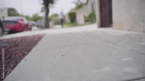 Wallpaper Mural A boy skateboarding down a sidewalk in a California neighborhood. Torontodigital.ca