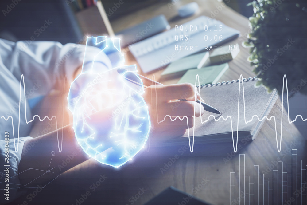 Heart hologram over woman's hands writing background. Concept of Medical study. Multi exposure Heart hologram over woman's hands writing background. Concept of Medical study. Multi exposure